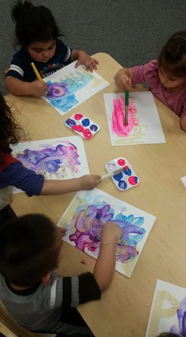 Children painting at a table