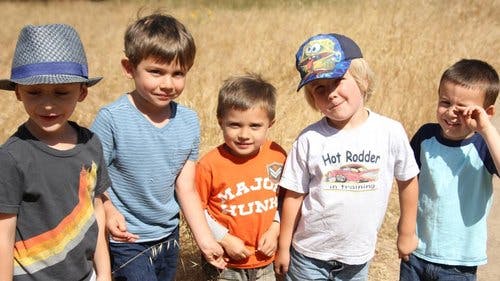 Five children standing together outdoors