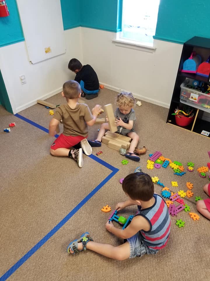 Children playing with blocks and toys on the floor