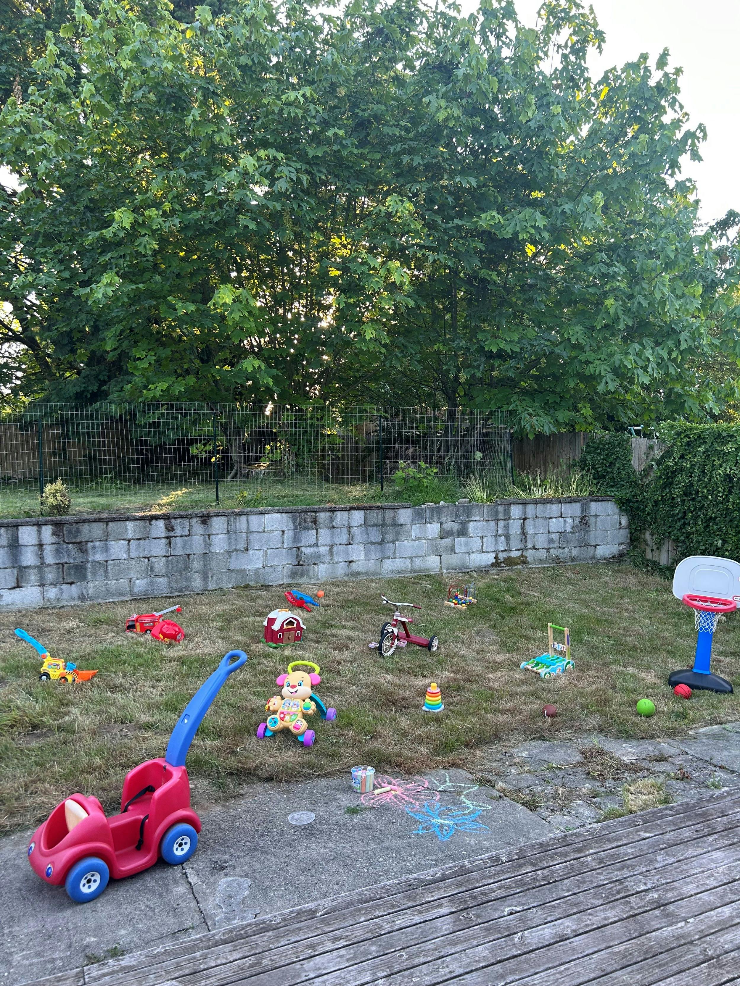 Various children's toys scattered on a grassy area