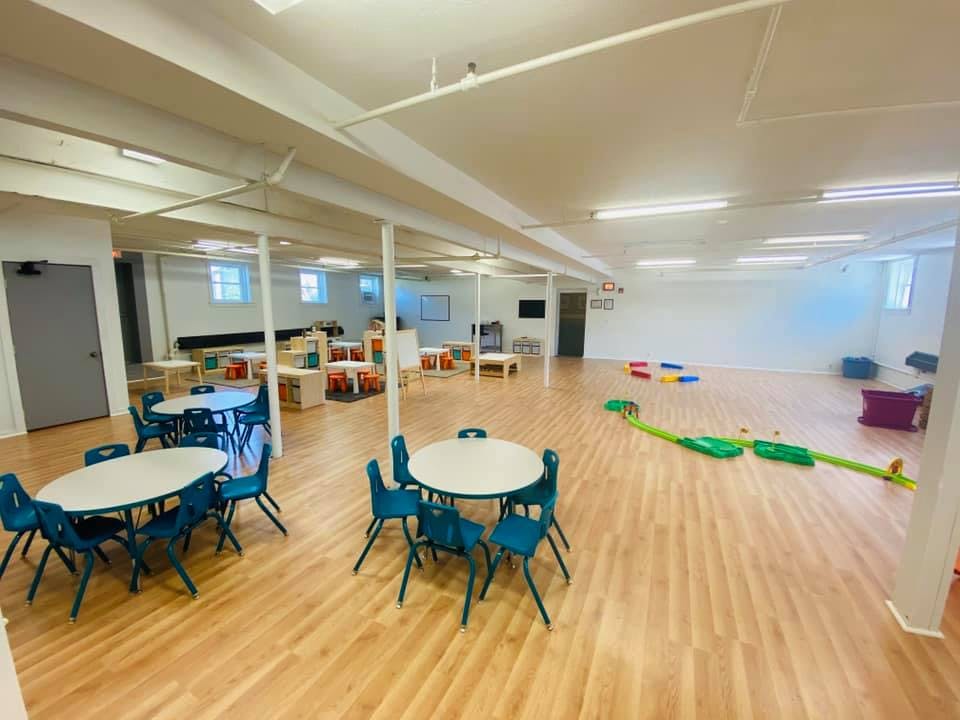 Empty classroom with small tables and chairs