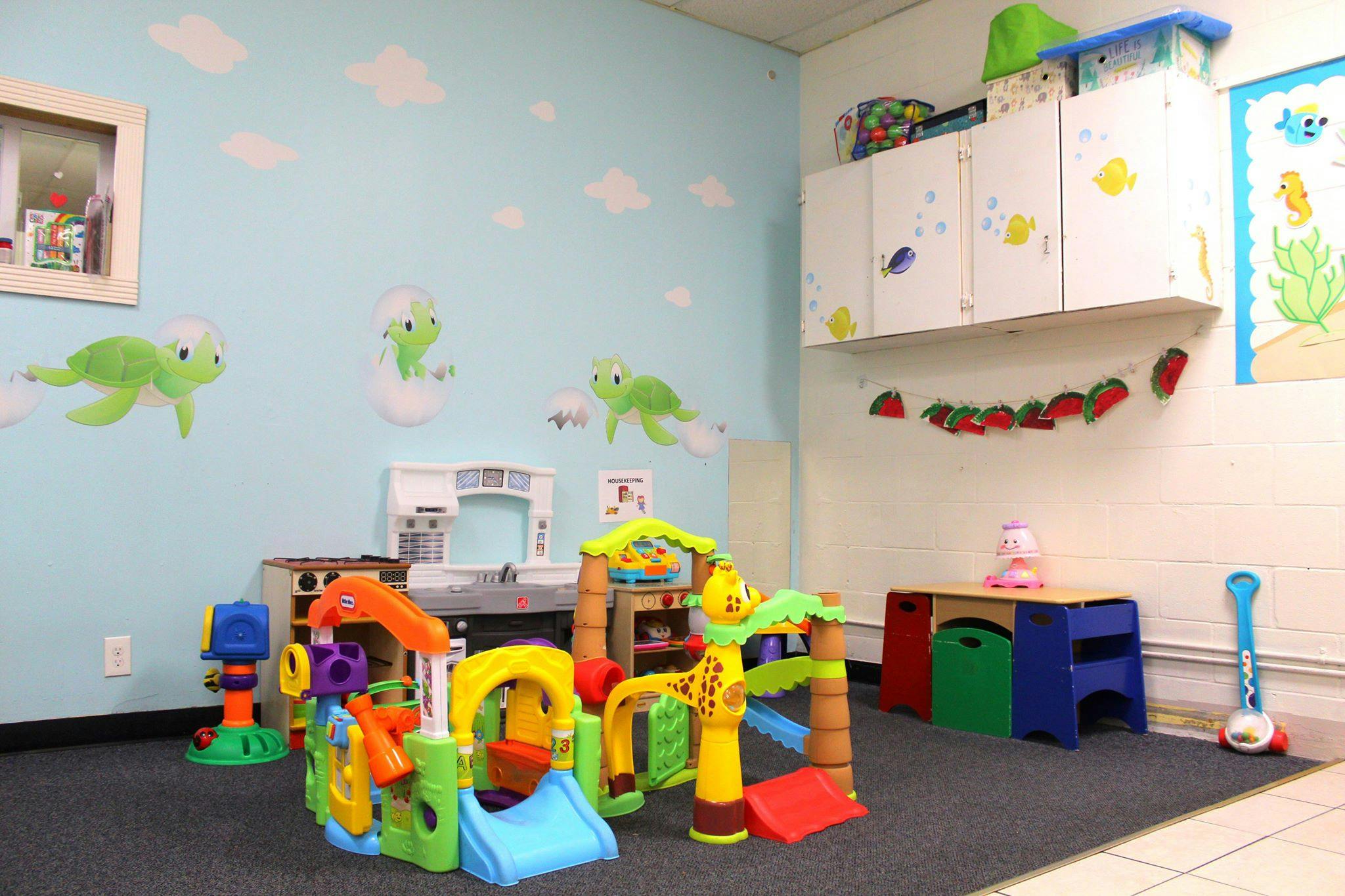 Playroom with colorful plastic play structure and toys