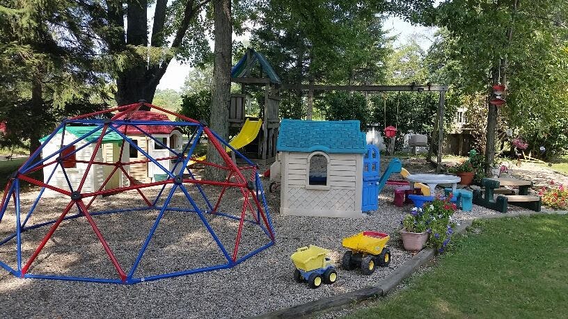 Playground with climbing dome, playhouse, and swing set
