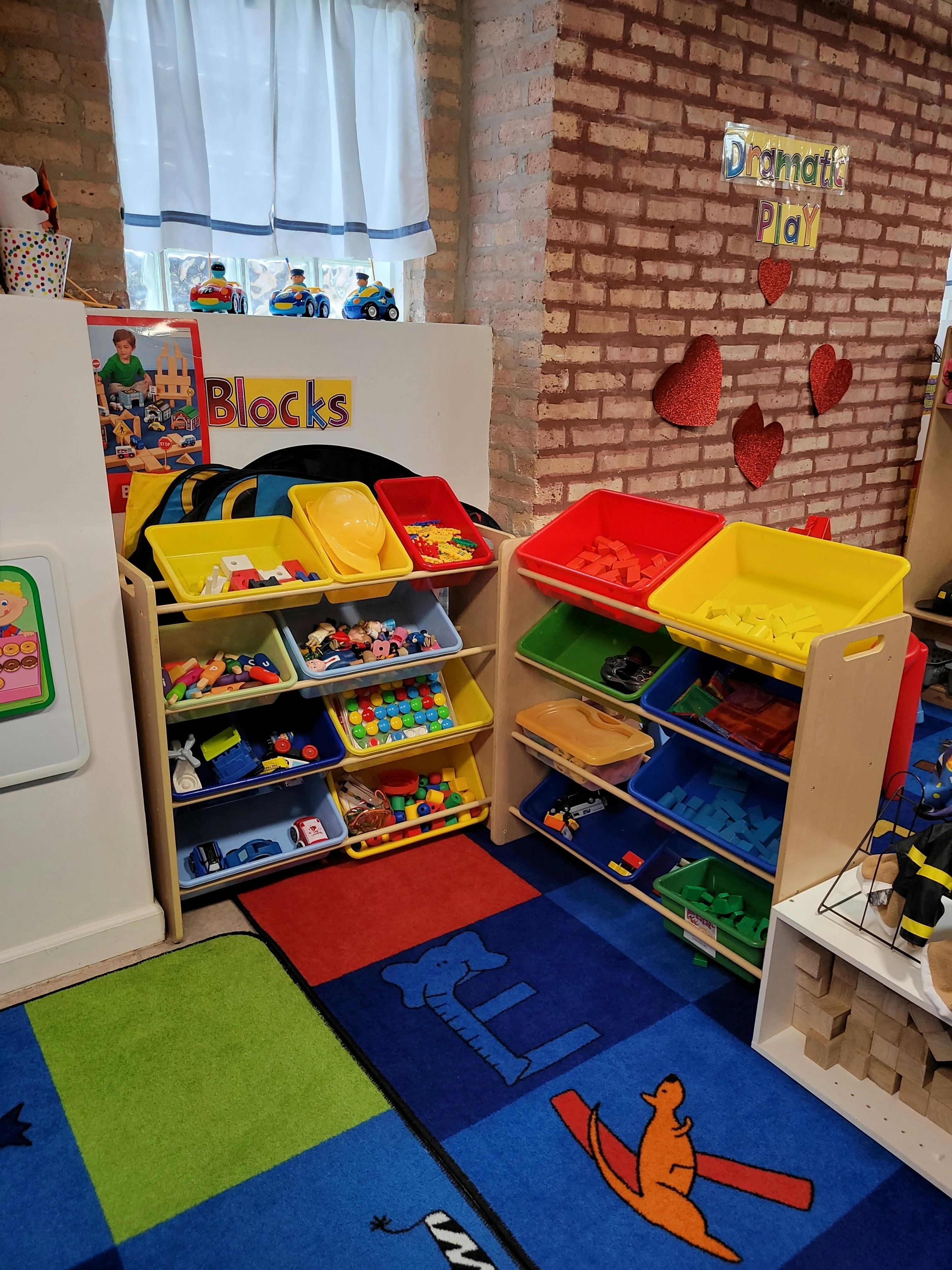 Playroom with toy storage shelves and colorful rugs