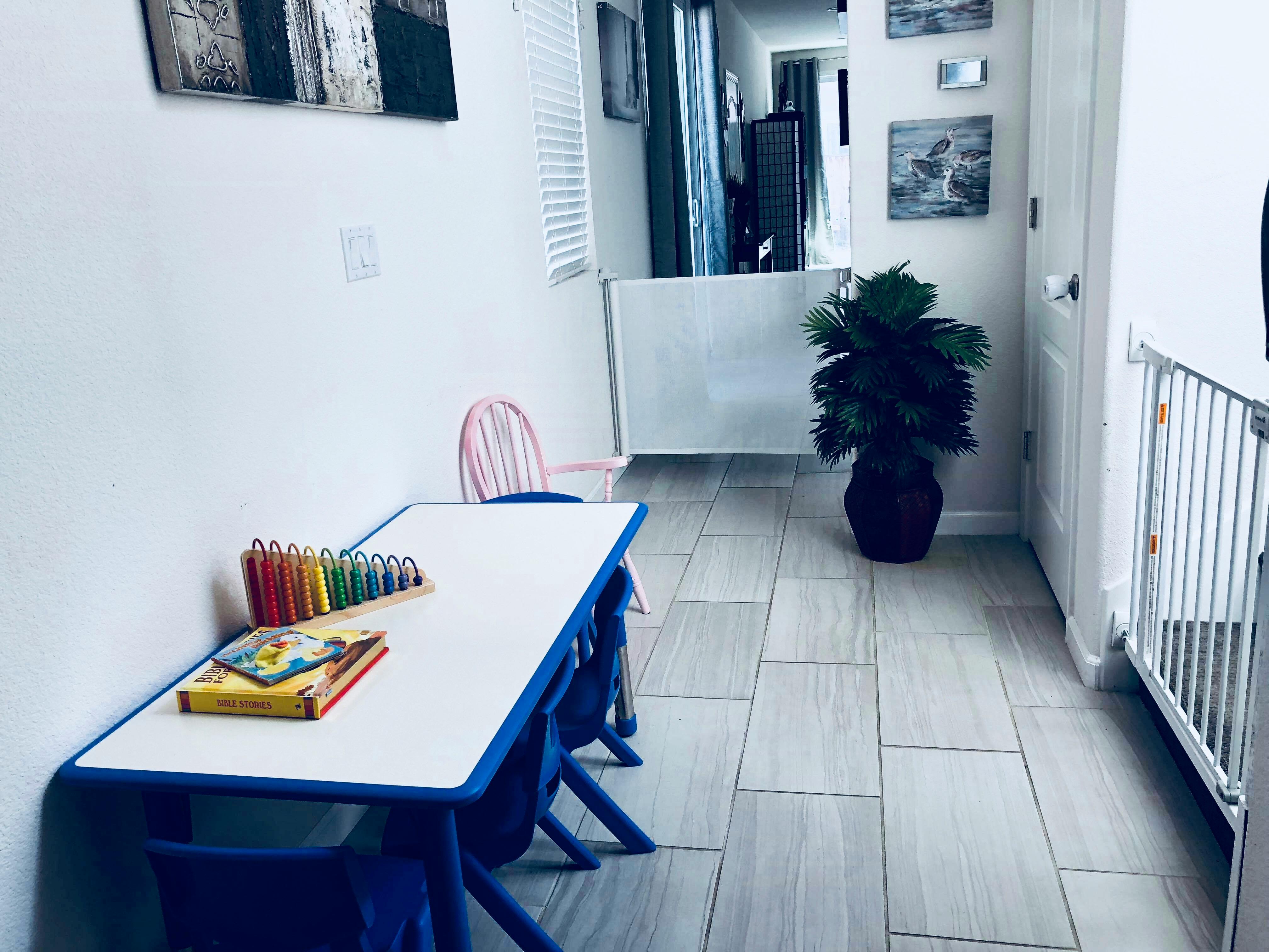 Children's table with crayons and books in a room