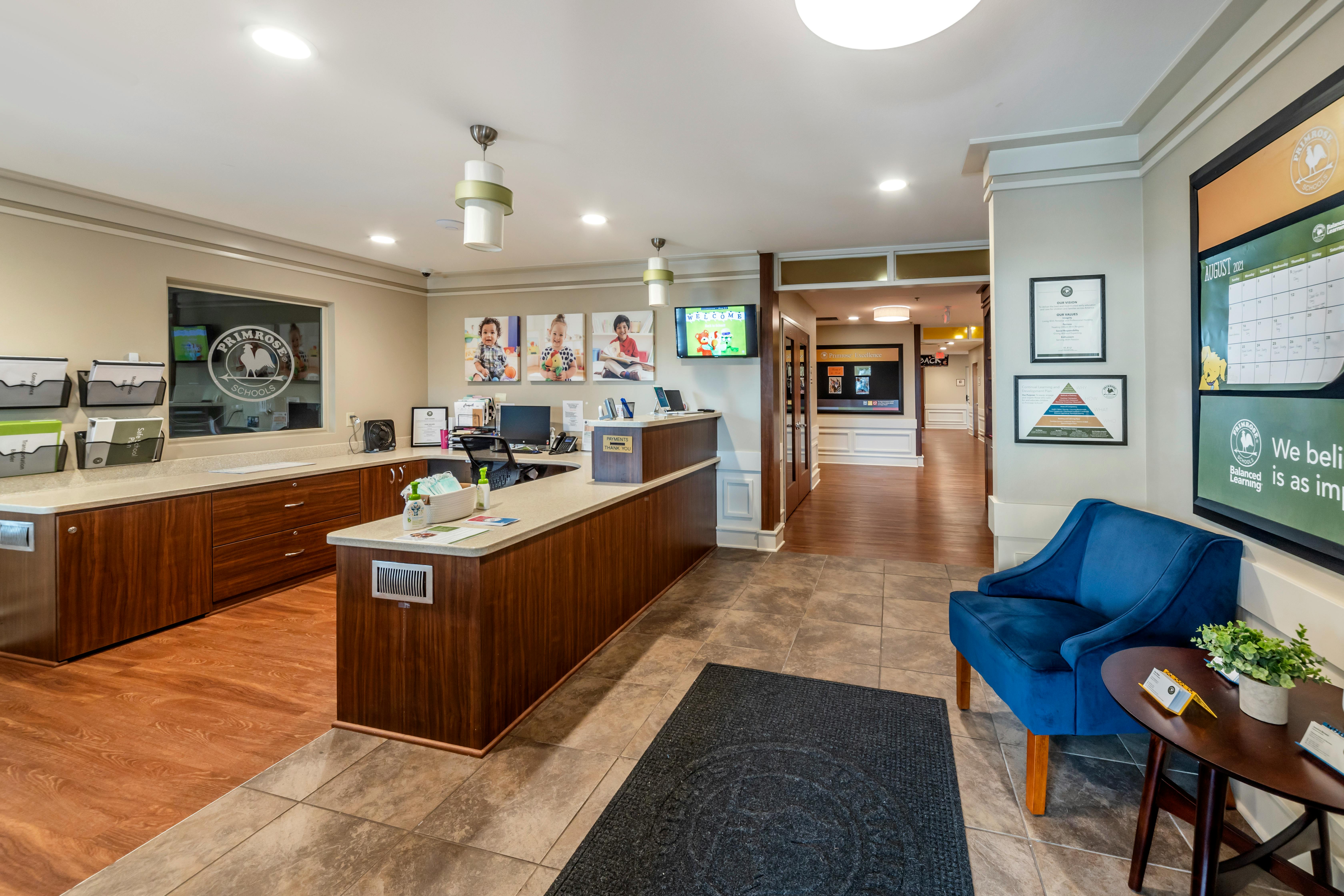 Reception desk with three framed photos of children above it