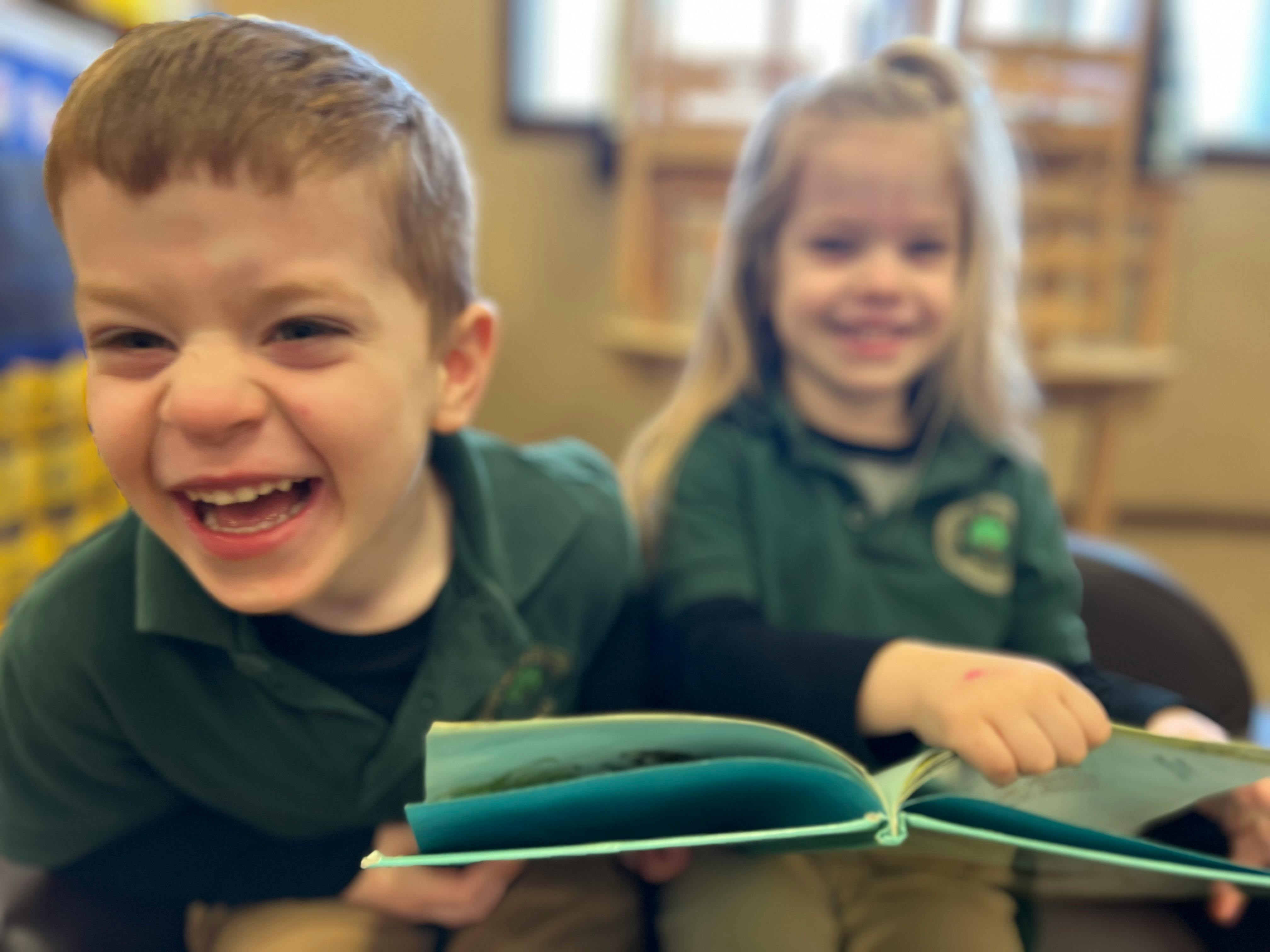 Two children reading a book together
