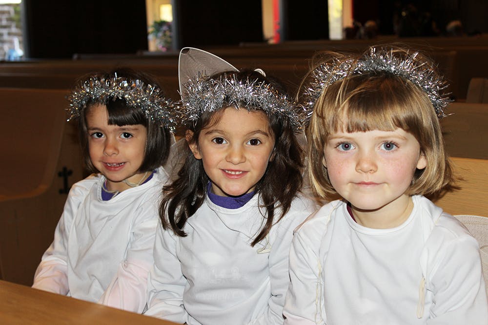 Three children wearing tinsel headbands