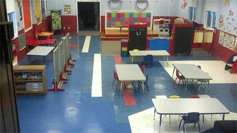 Empty classroom with small tables and chairs