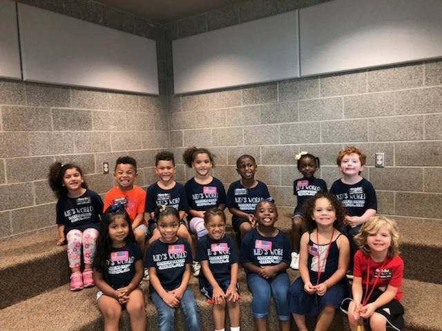 Group of children sitting on steps