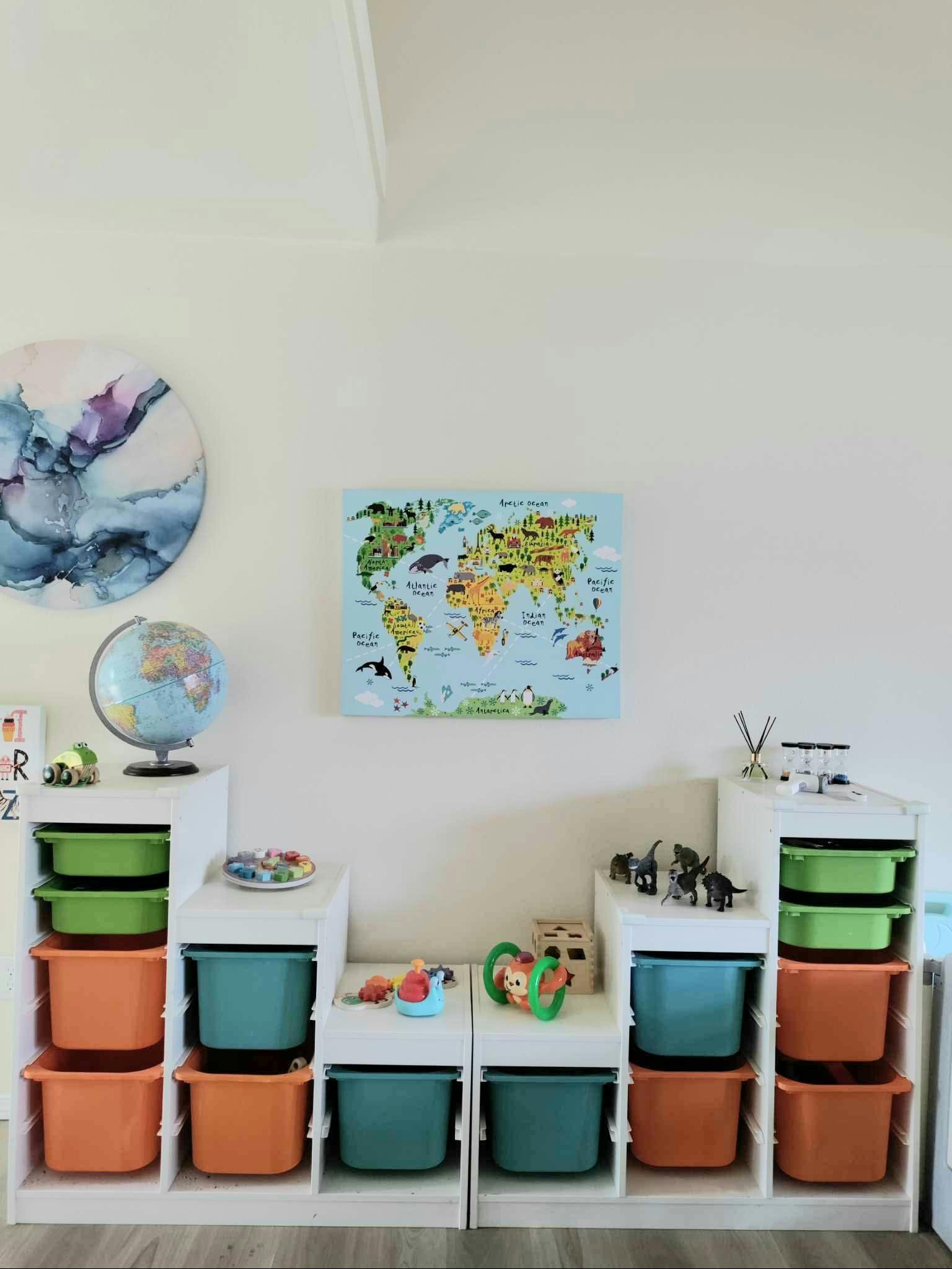 Children's room with storage bins, a globe, and a world map on the wall