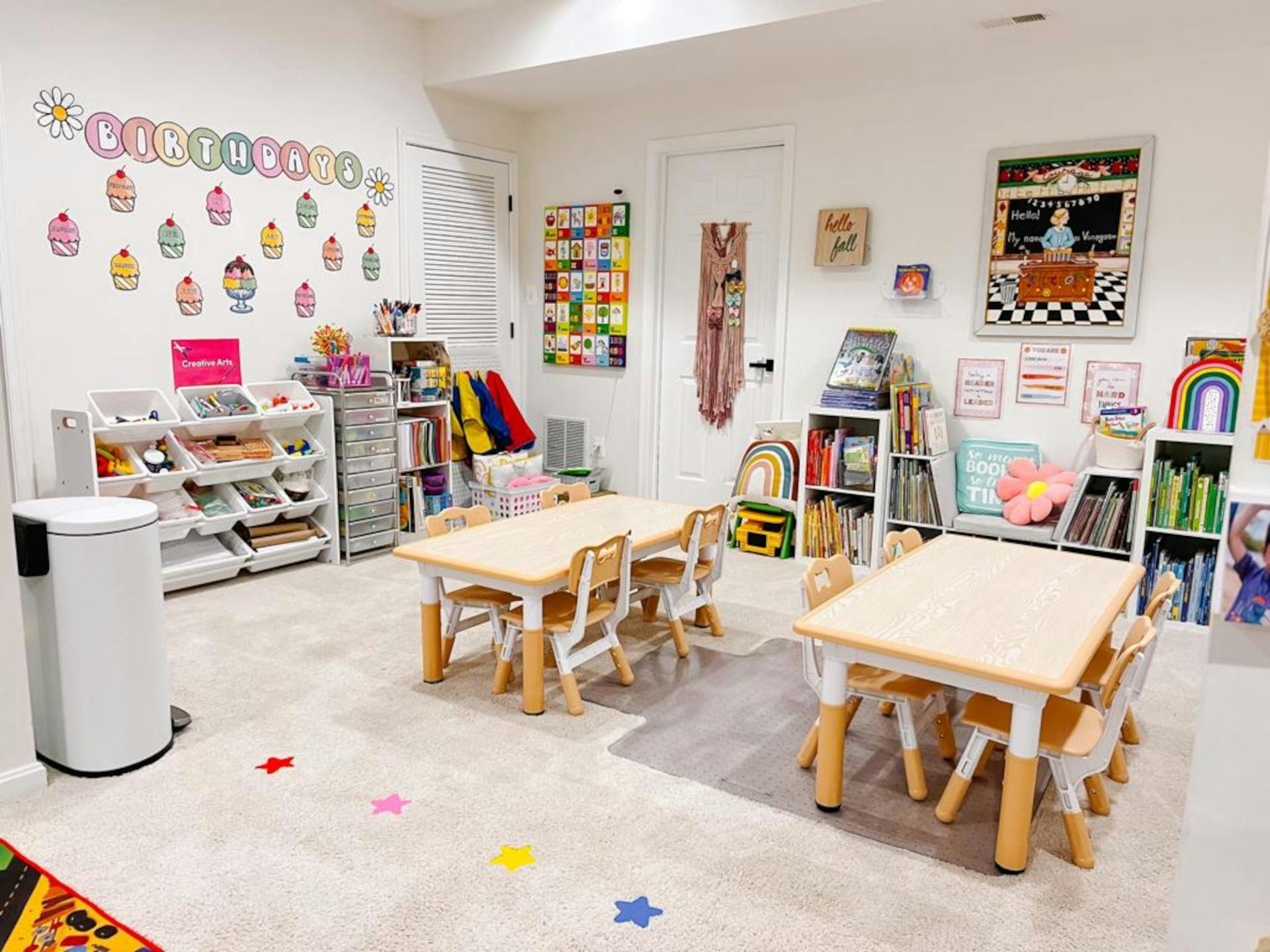 Classroom with small tables and chairs, bookshelves, and wall decorations