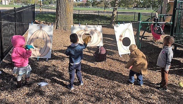 Children playing a game with targets on a playground
