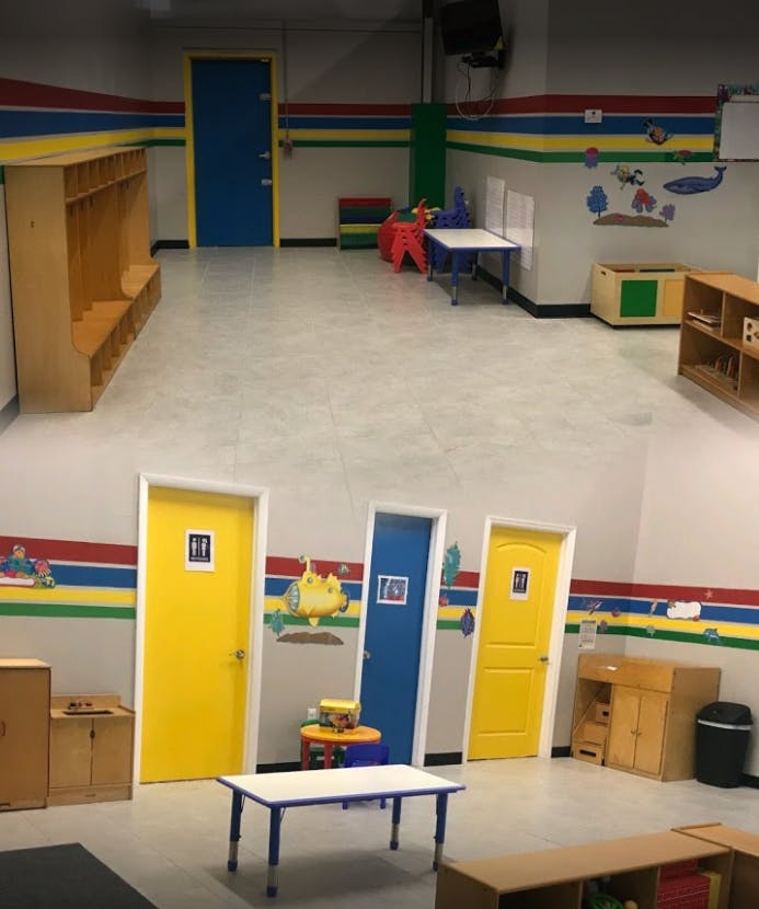 Empty classroom with colorful doors and children's furniture
