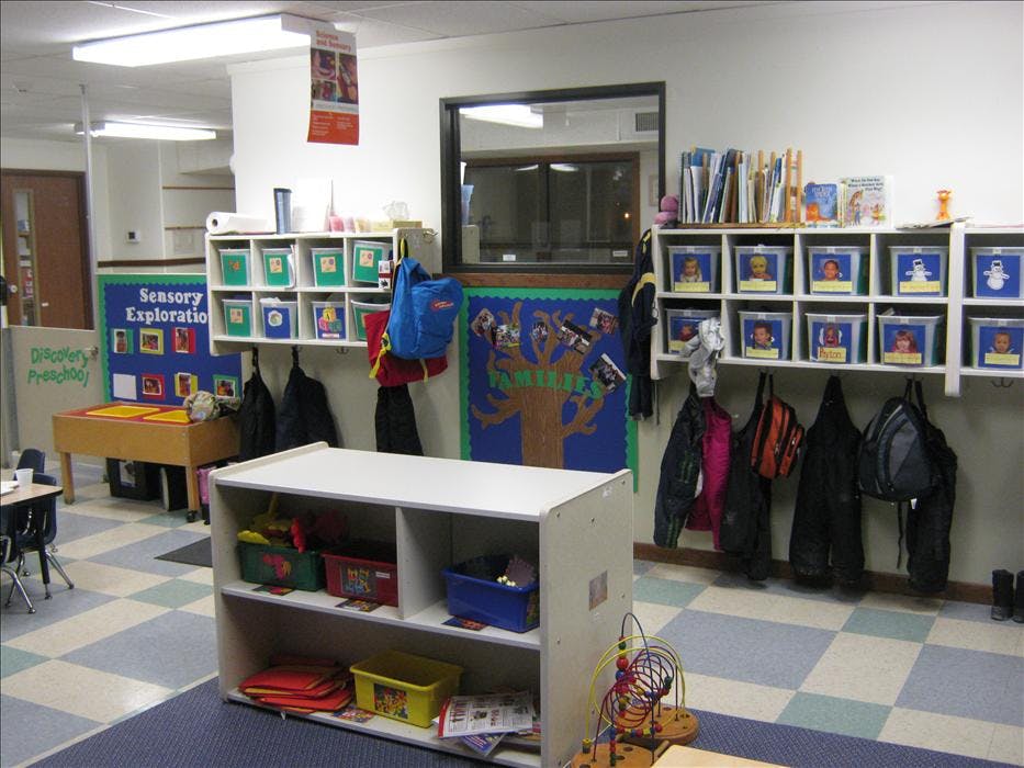 preschool classroom with cubbies, coats, and activity areas
