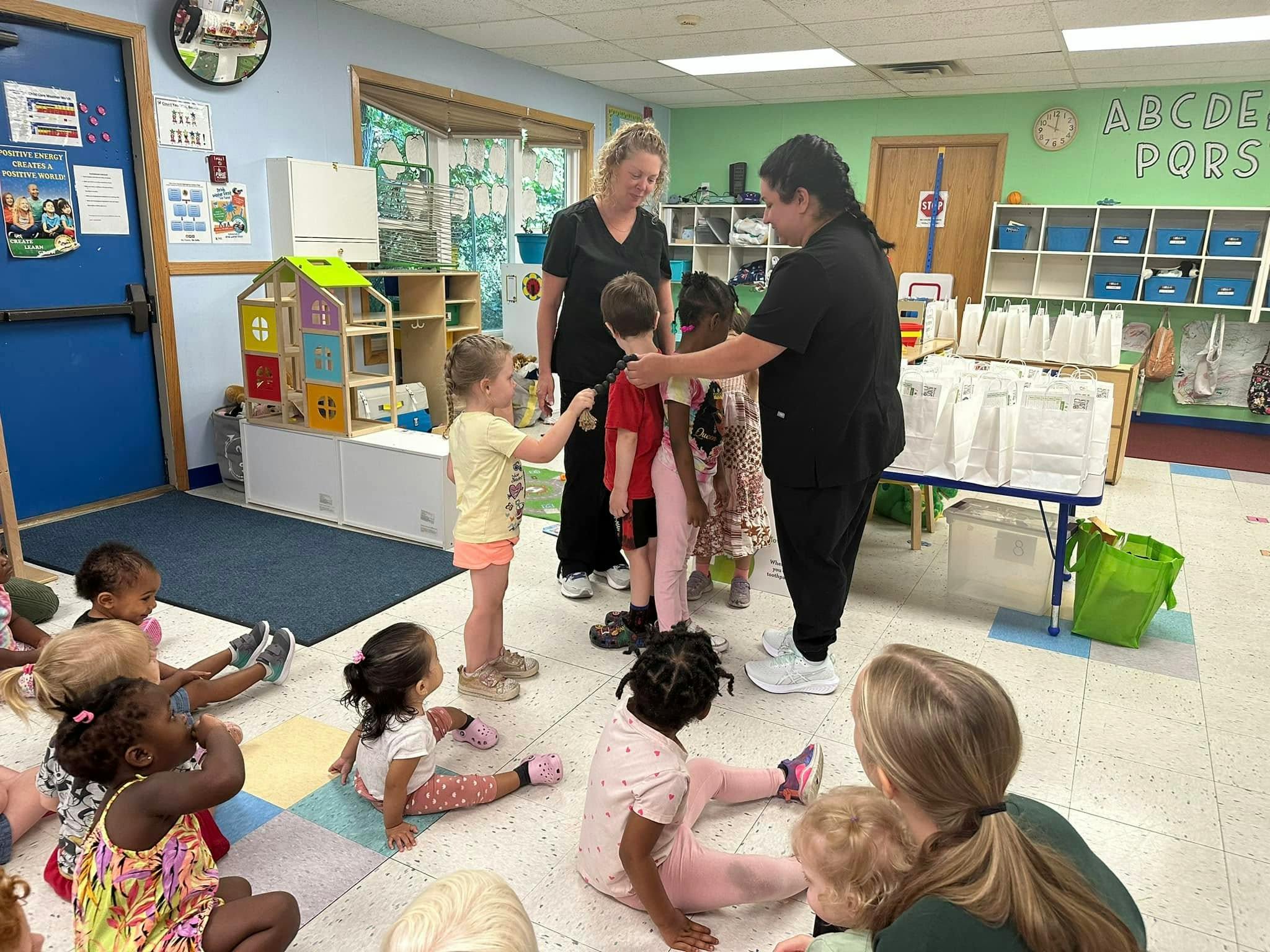 Adults interacting with children in a classroom
