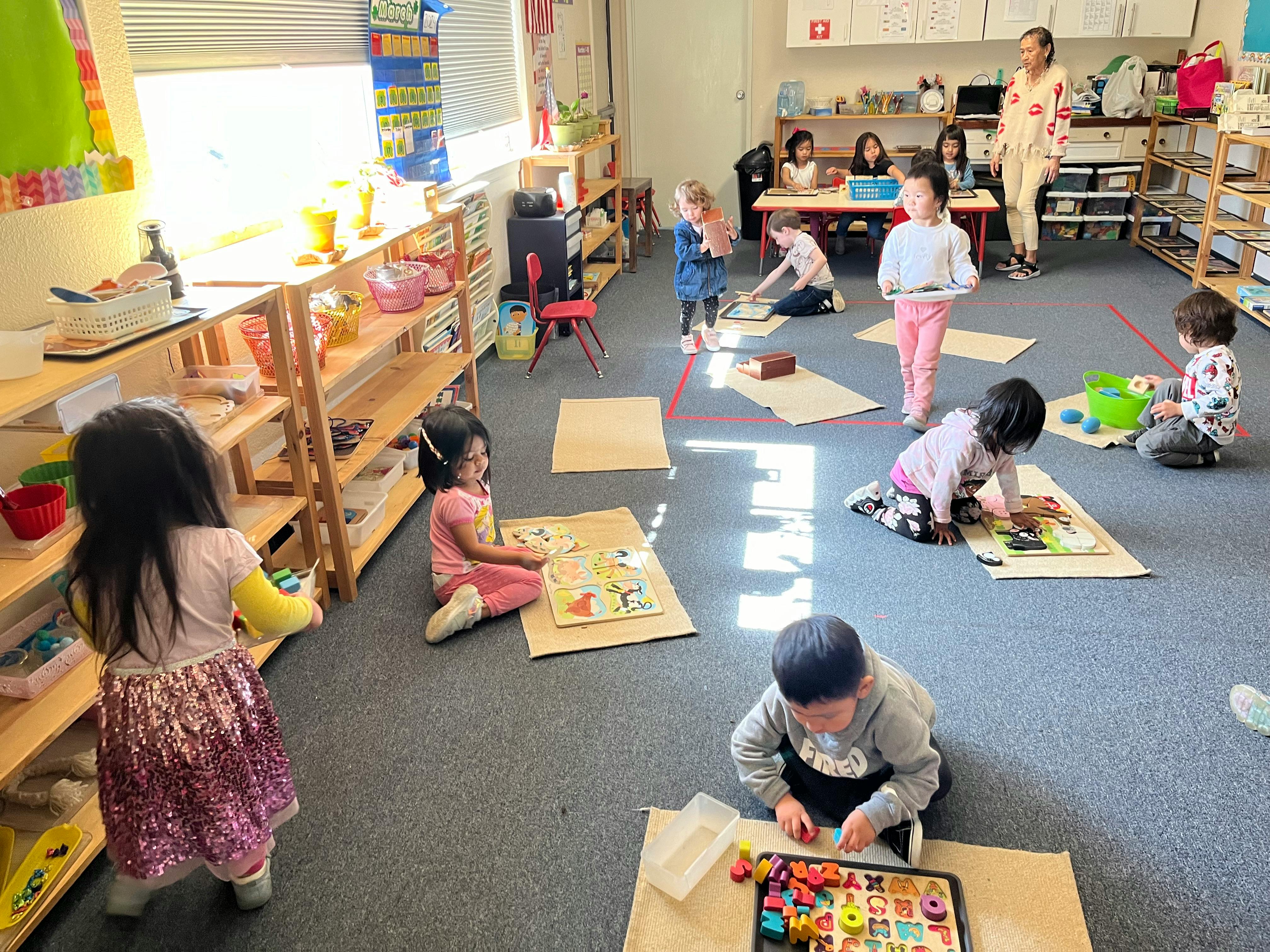 Children playing with toys and puzzles in a classroom