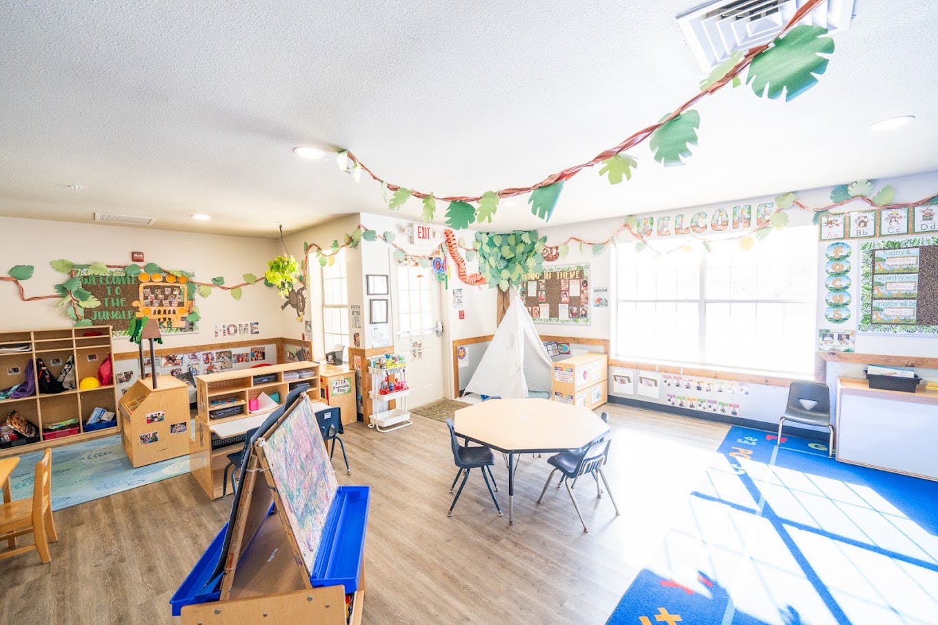 Classroom decorated with a jungle theme including a play tent and learning area