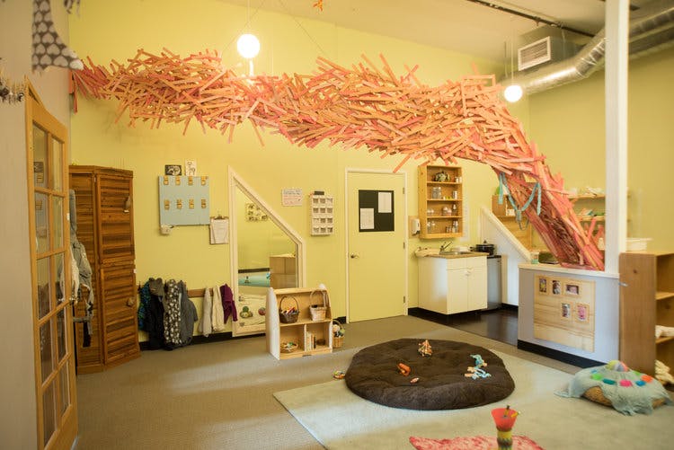 Indoor play area with a large orange art installation on the ceiling