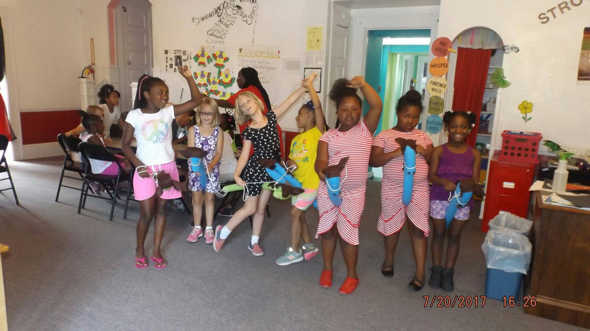 Group of children holding blue objects