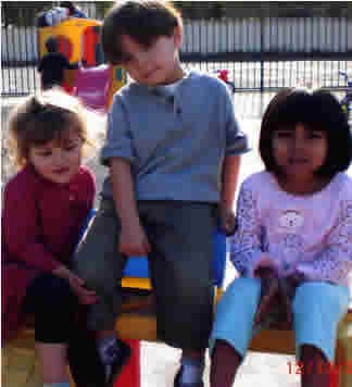 Three children sitting on a bench