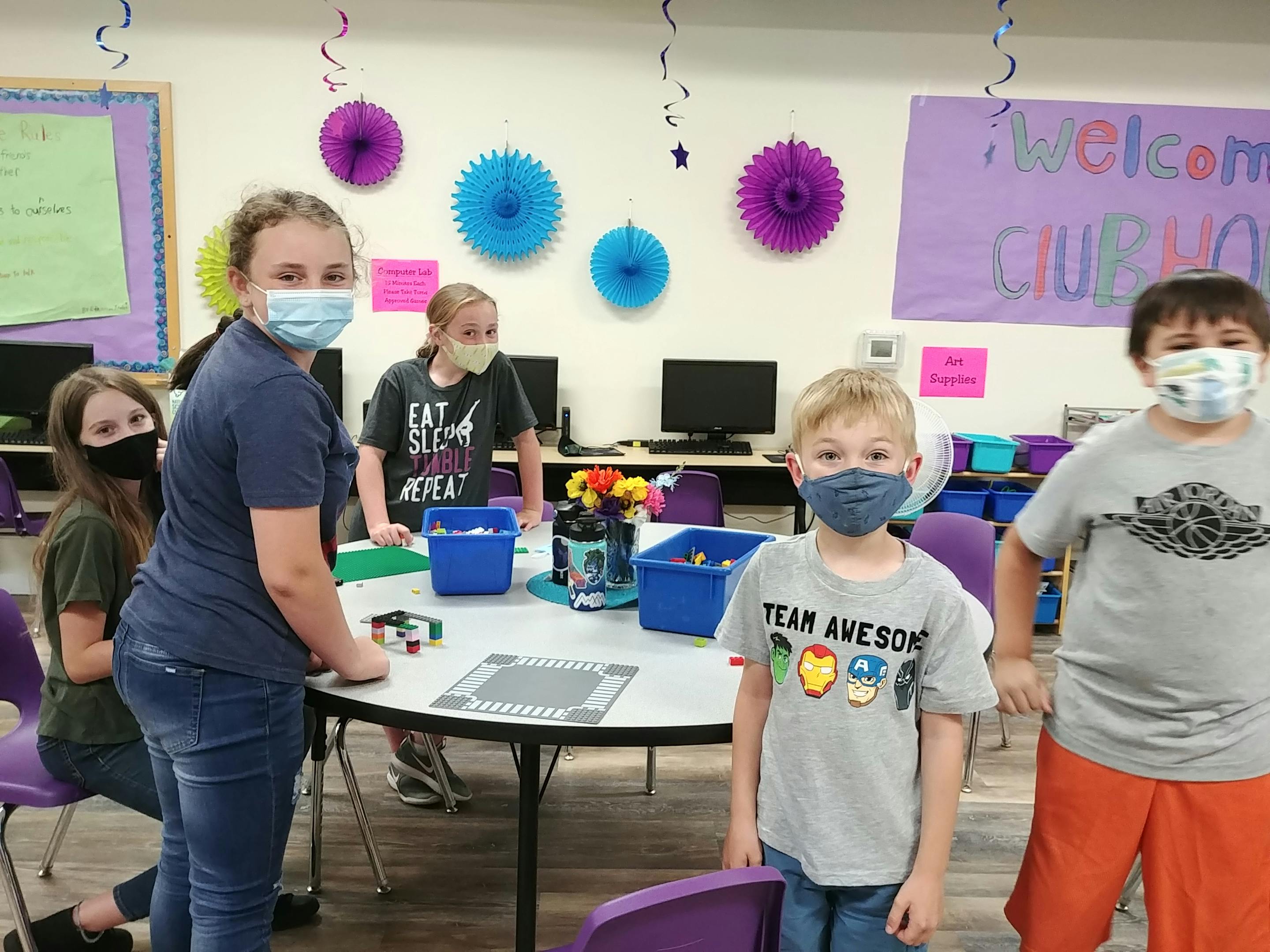 Children and teens wearing masks in a classroom