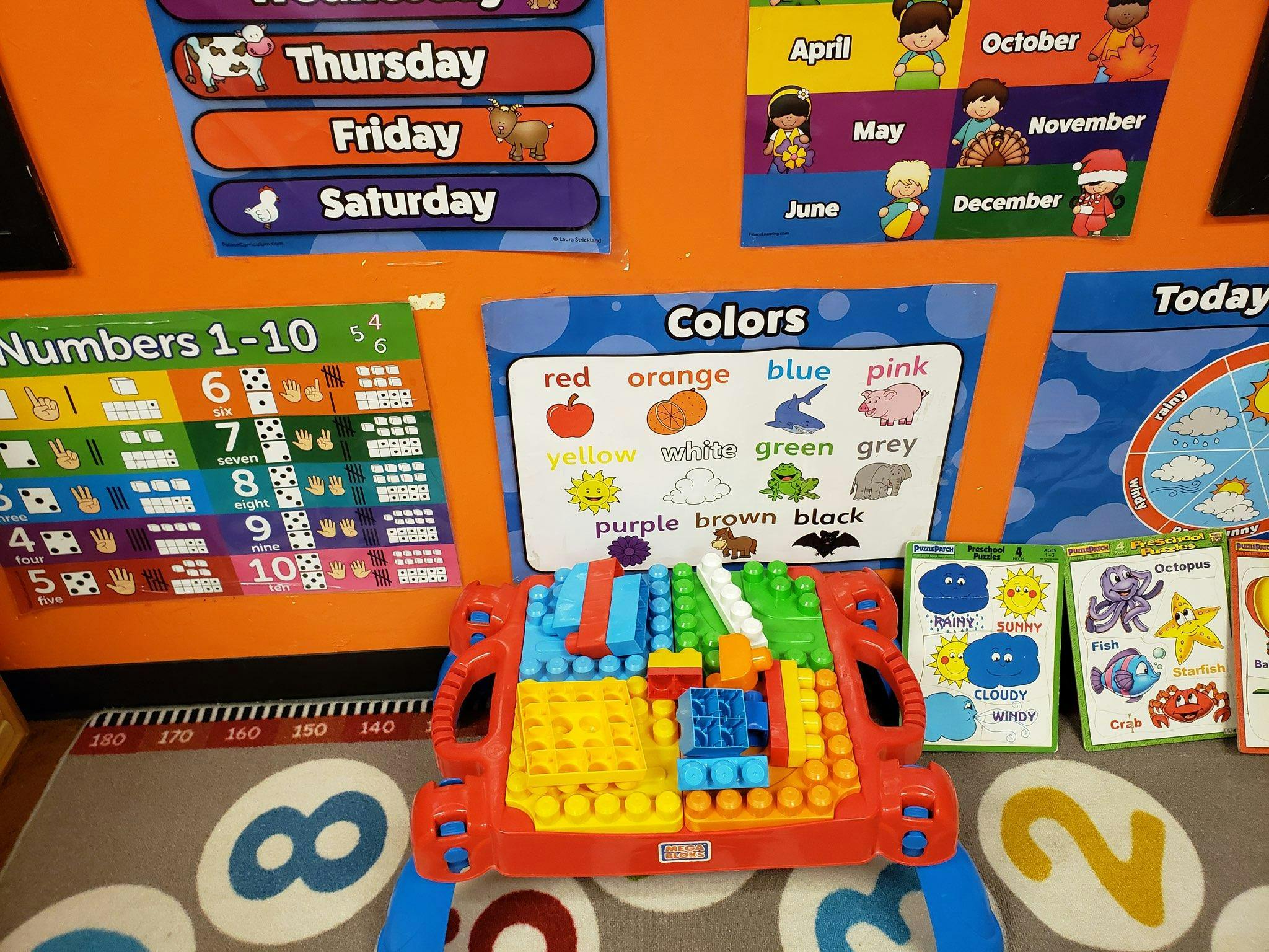 Colorful building blocks on a play table in a classroom setting
