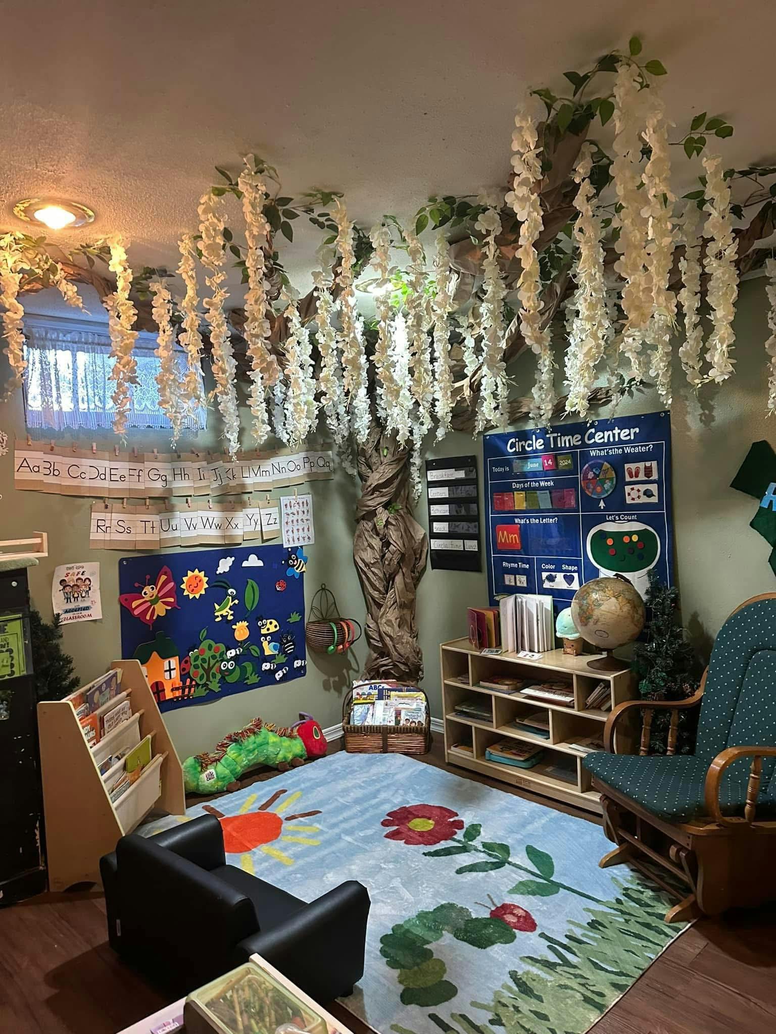 Children's play area with a colorful rug, small furniture, and wall decorations
