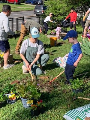 People and children planting in a garden