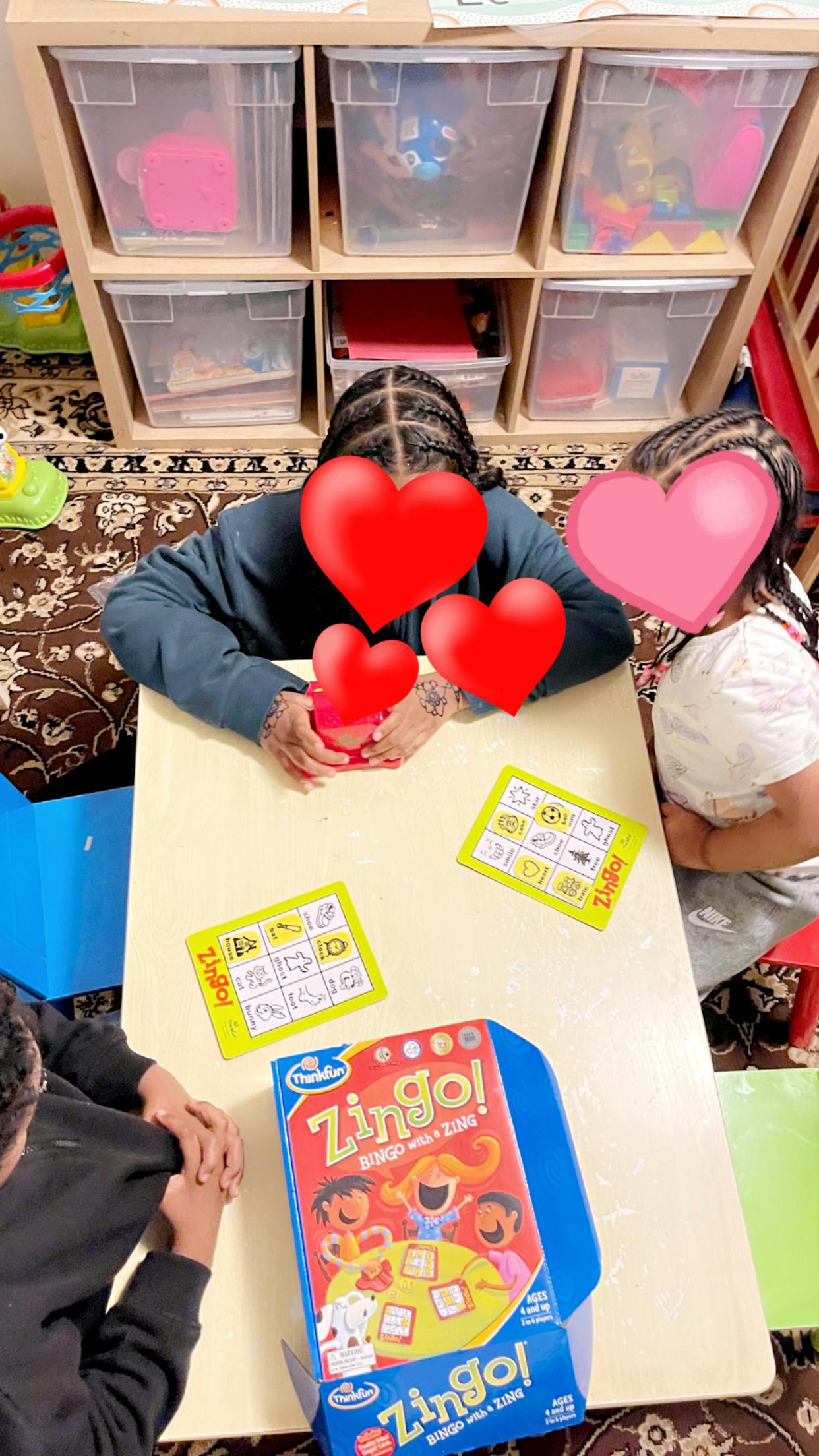 People playing the Zingo! board game at a table