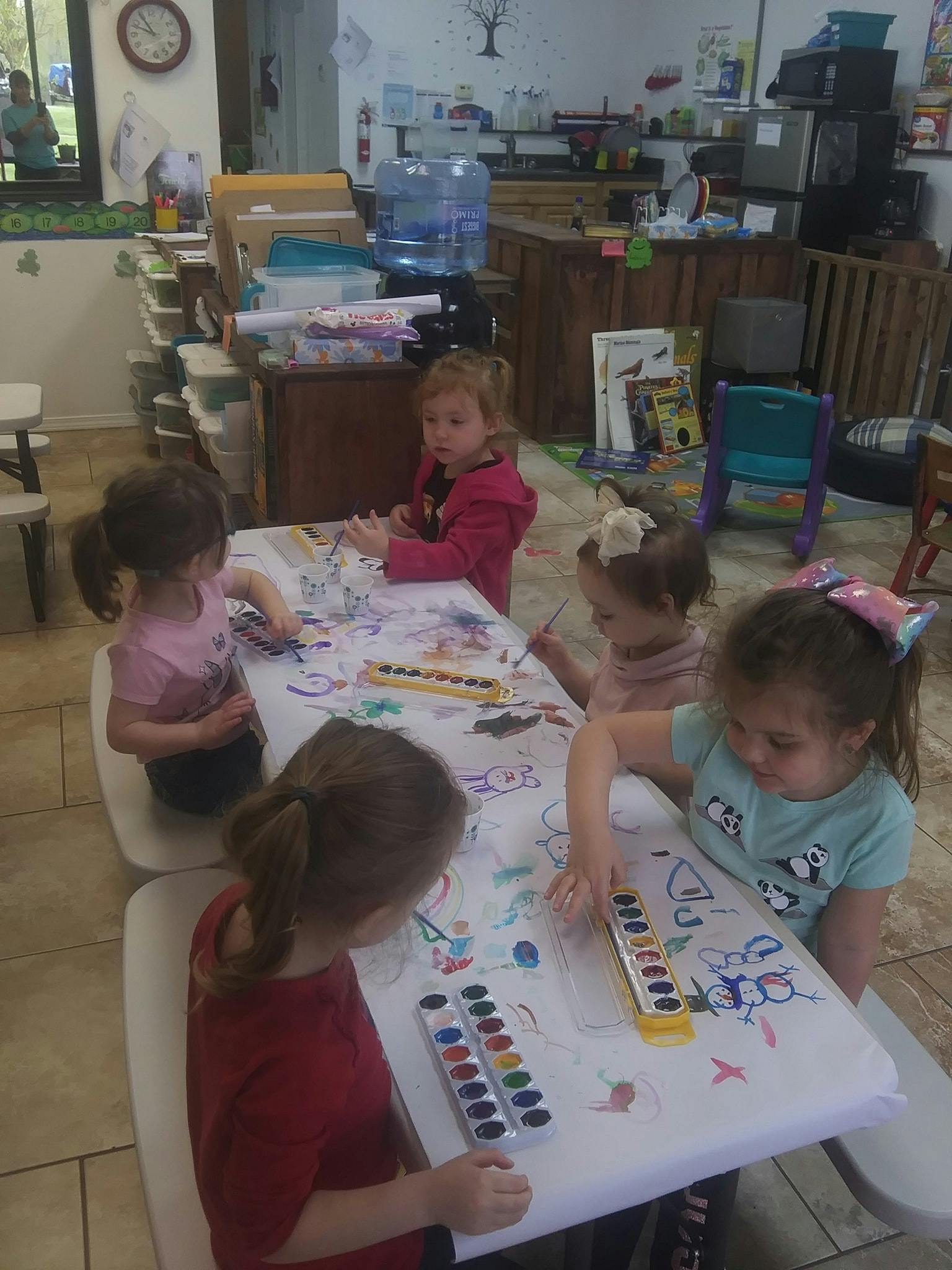 Children painting at a table