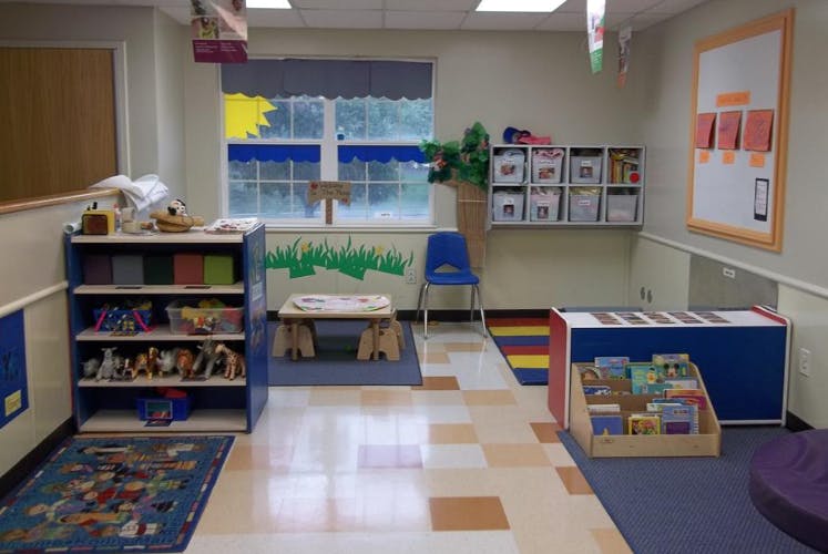 A colorful classroom with toys, books, and child-sized furniture
