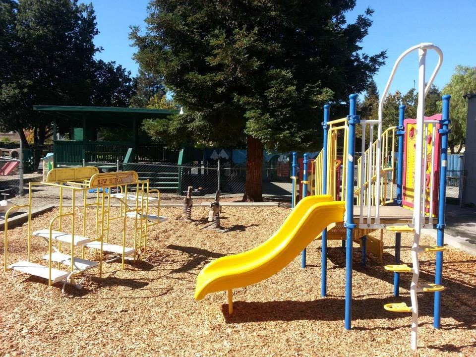 Playground with yellow slide and climbing structure