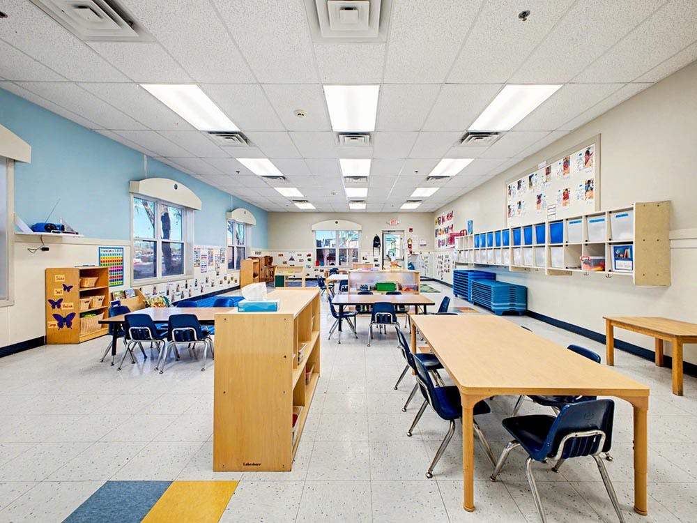 Empty classroom with small tables and chairs