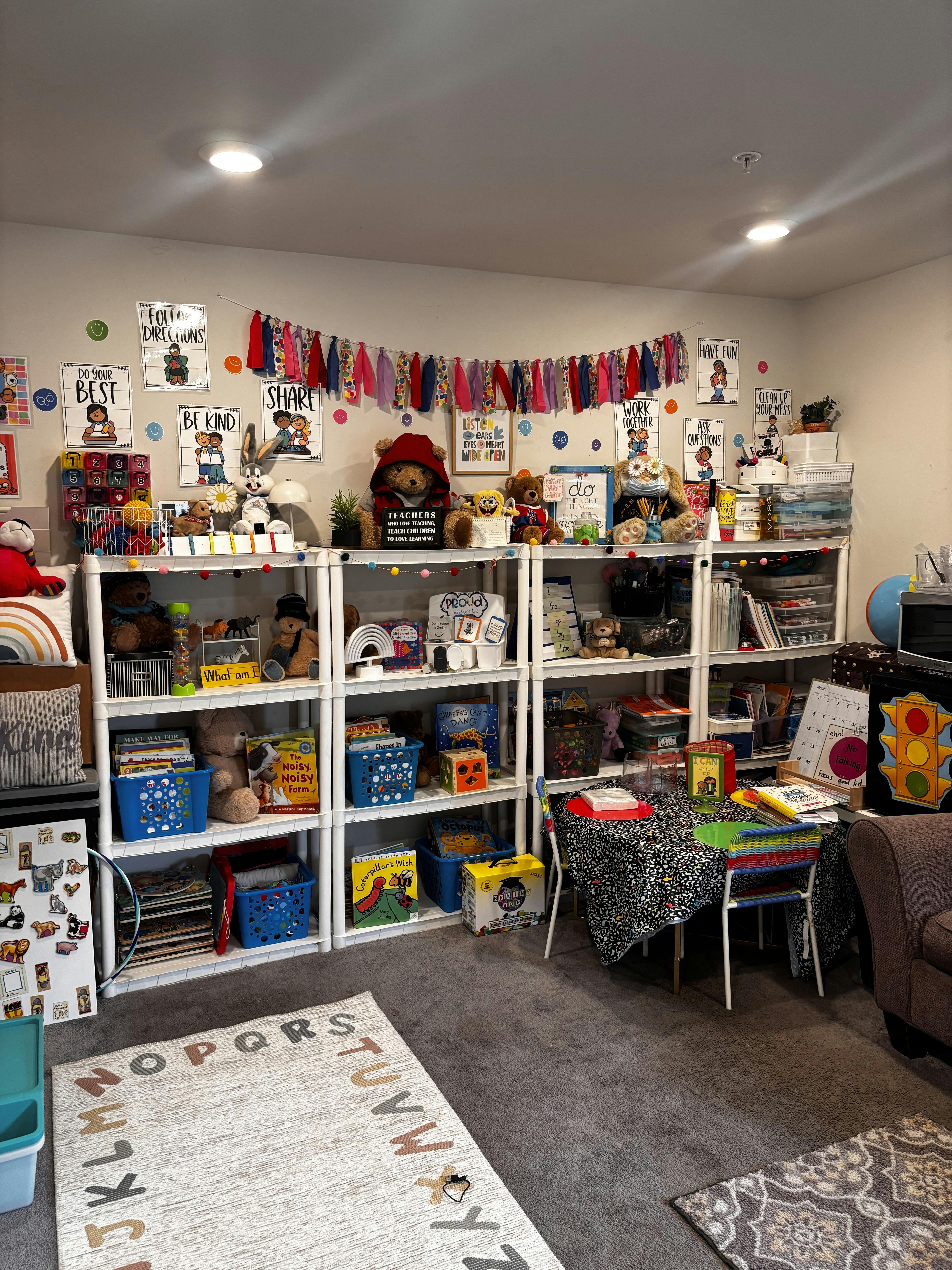 Classroom filled with shelves of toys and books, posters on the wall