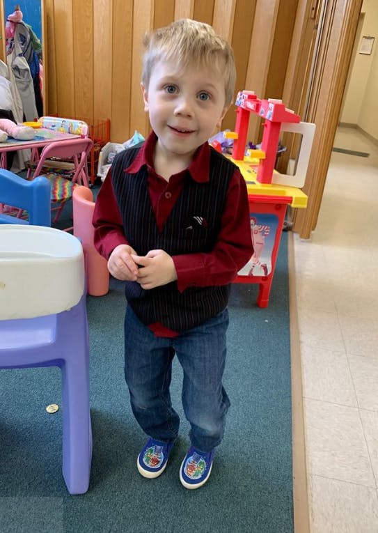 Child standing in a room with toys
