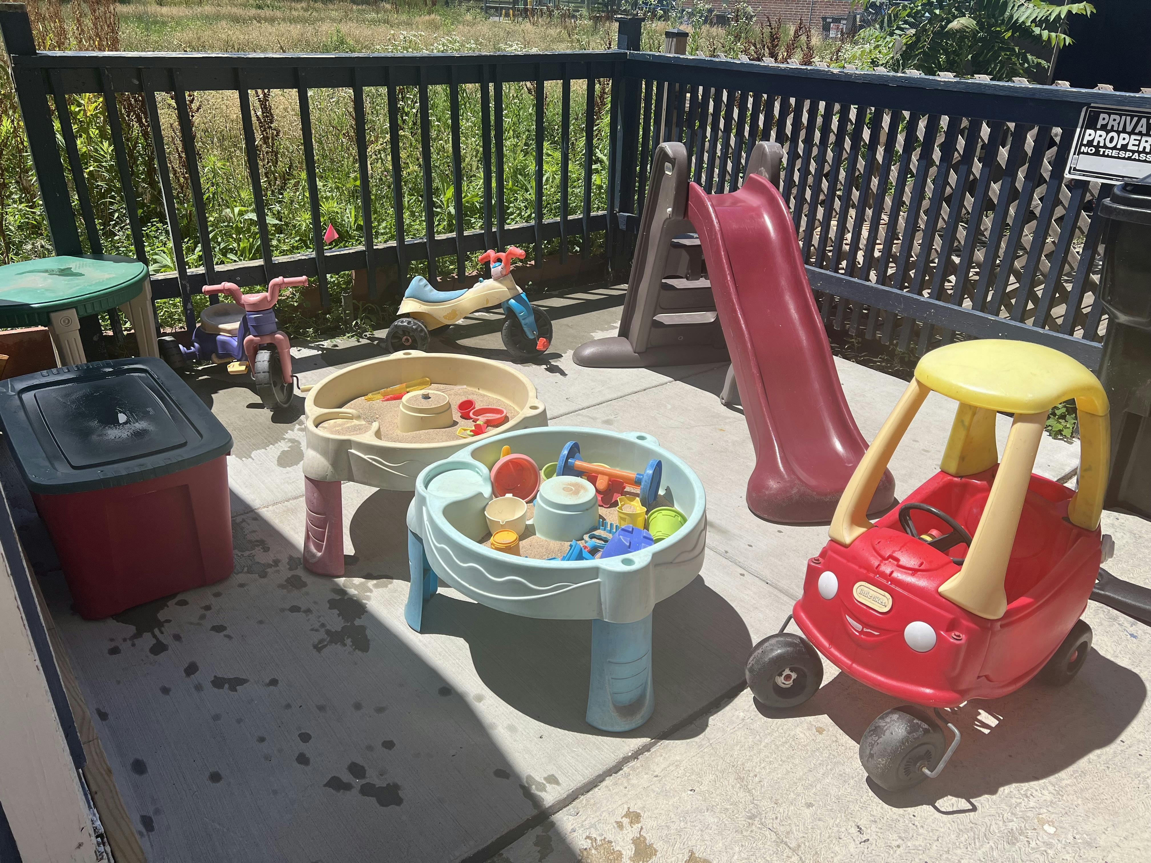 Plastic outdoor play equipment and toys on a patio