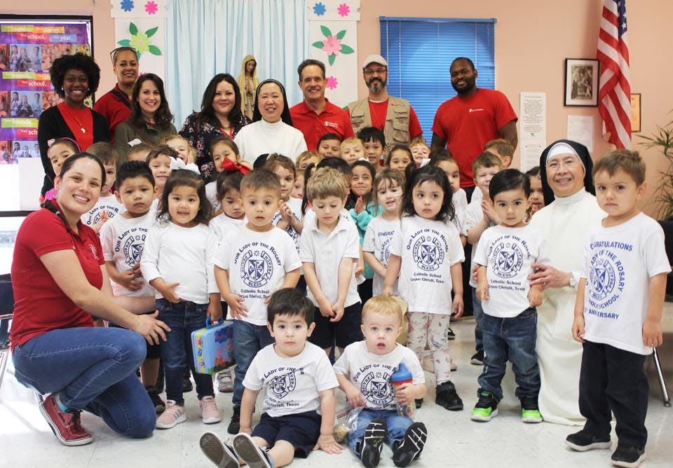 Adults and children posing for a group photo