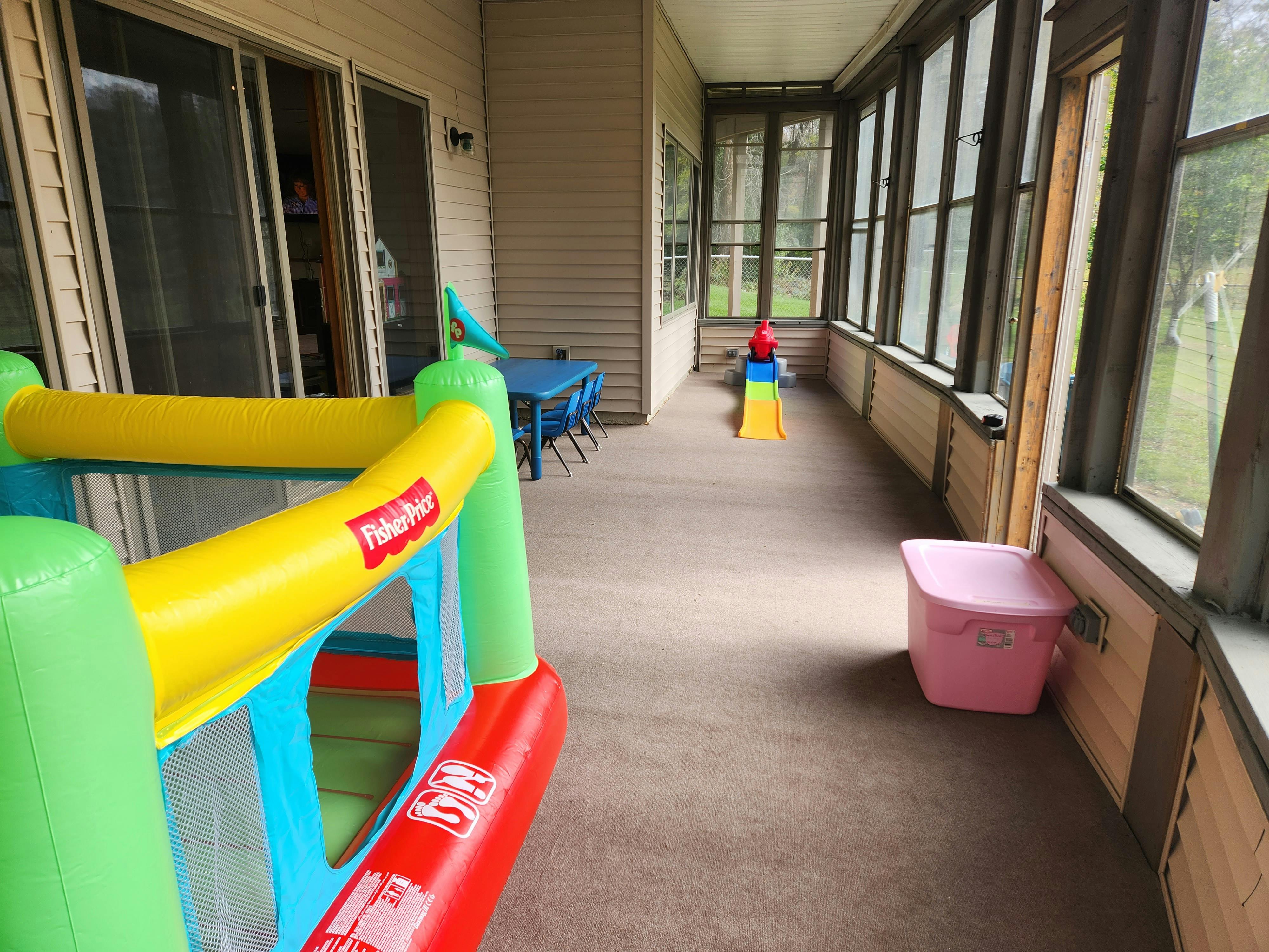 Inflatable bounce house on a screened-in porch