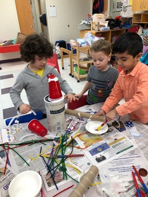 Three children doing crafts at a table