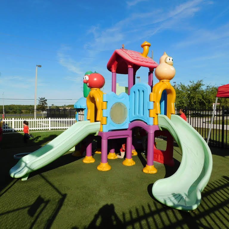 Colorful playground structure with slides on green turf