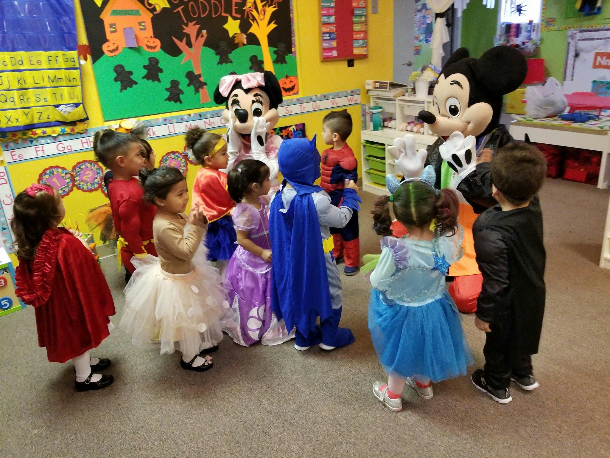 Children in costumes interacting with people in character costumes