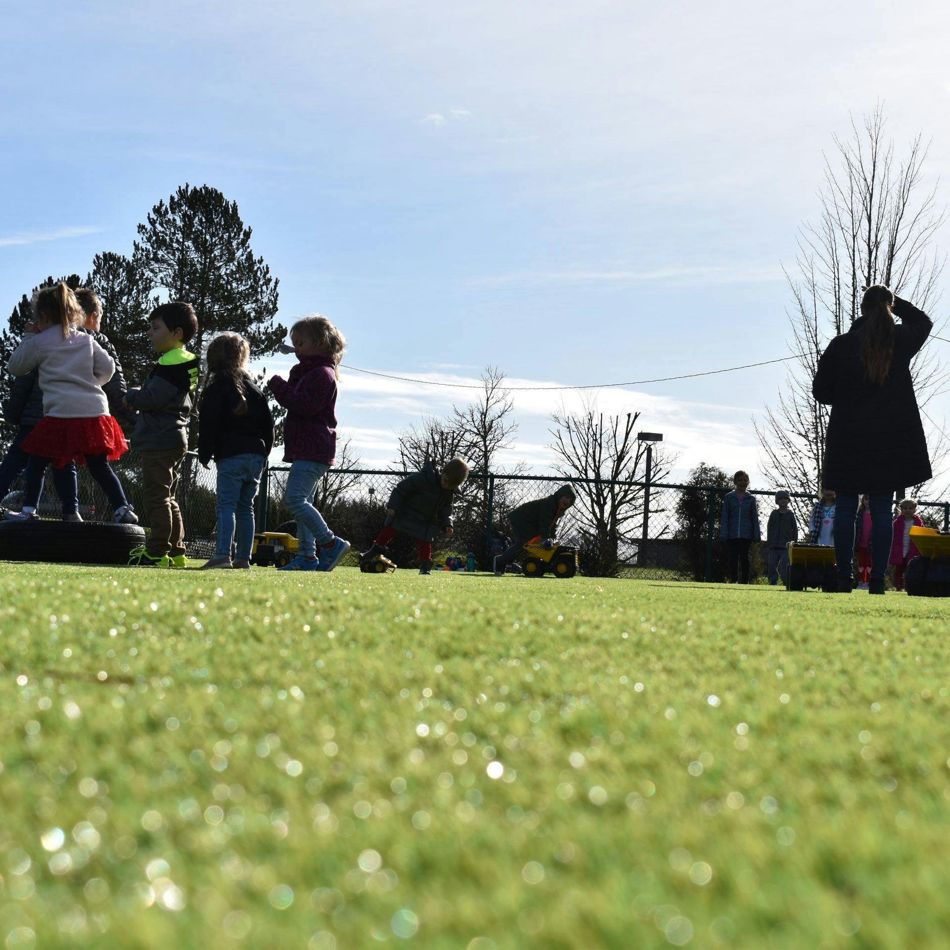 Children and adults on a grassy field