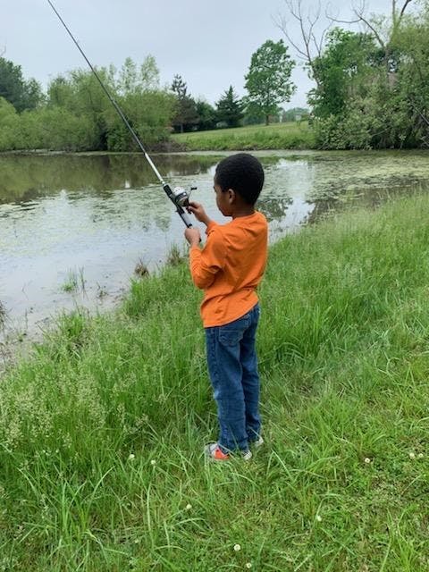 Child fishing in a pond