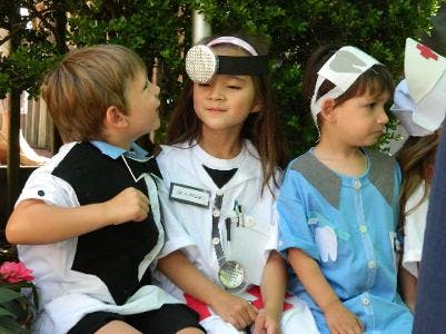 Three children dressed in doctor and nurse costumes