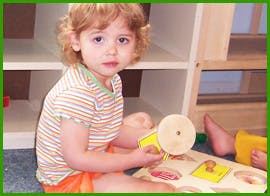Child playing with a wooden toy
