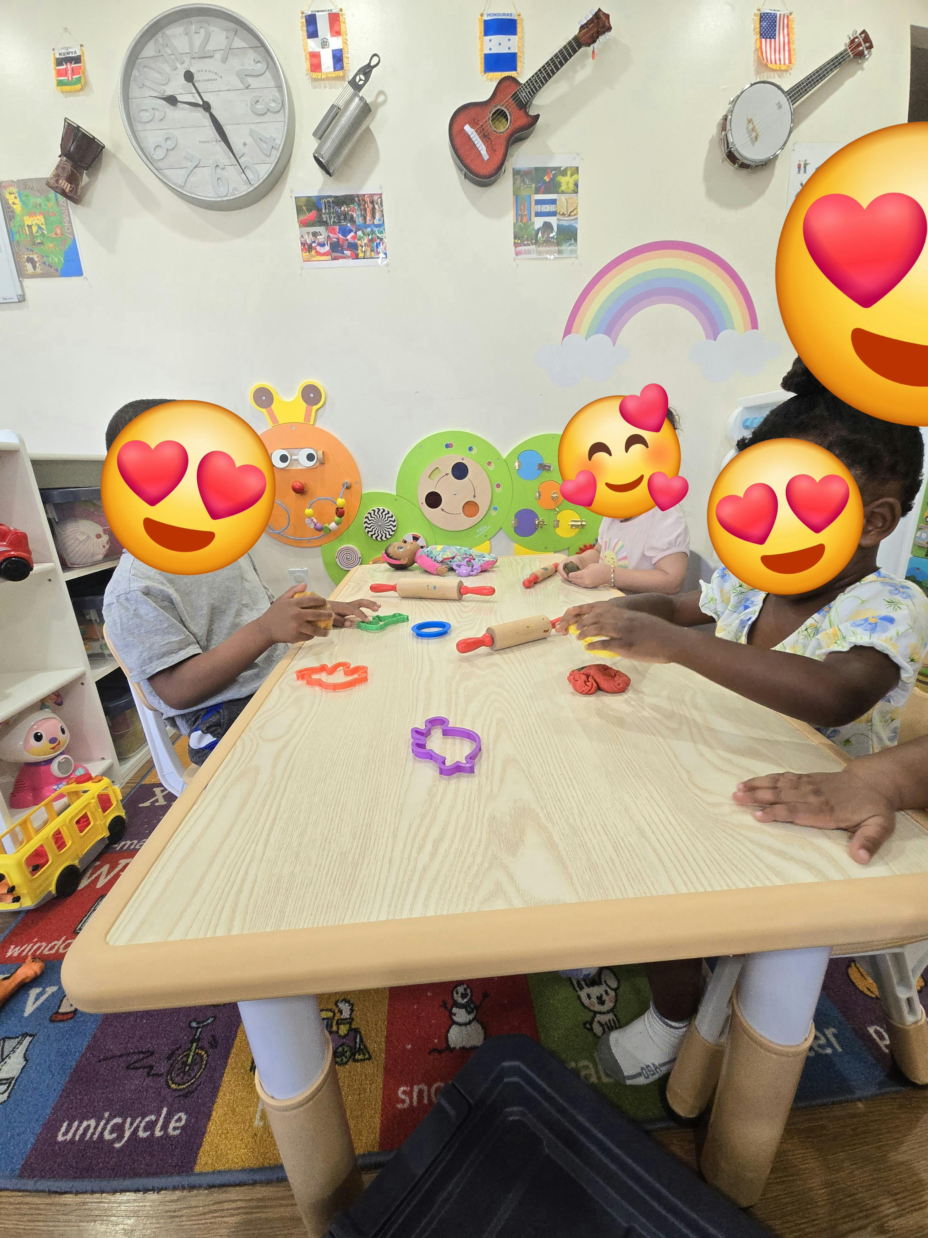 Children at a table with playdough and cookie cutters