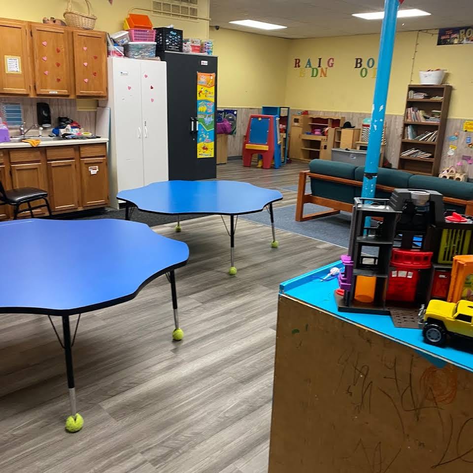 Classroom with blue tables and various learning materials