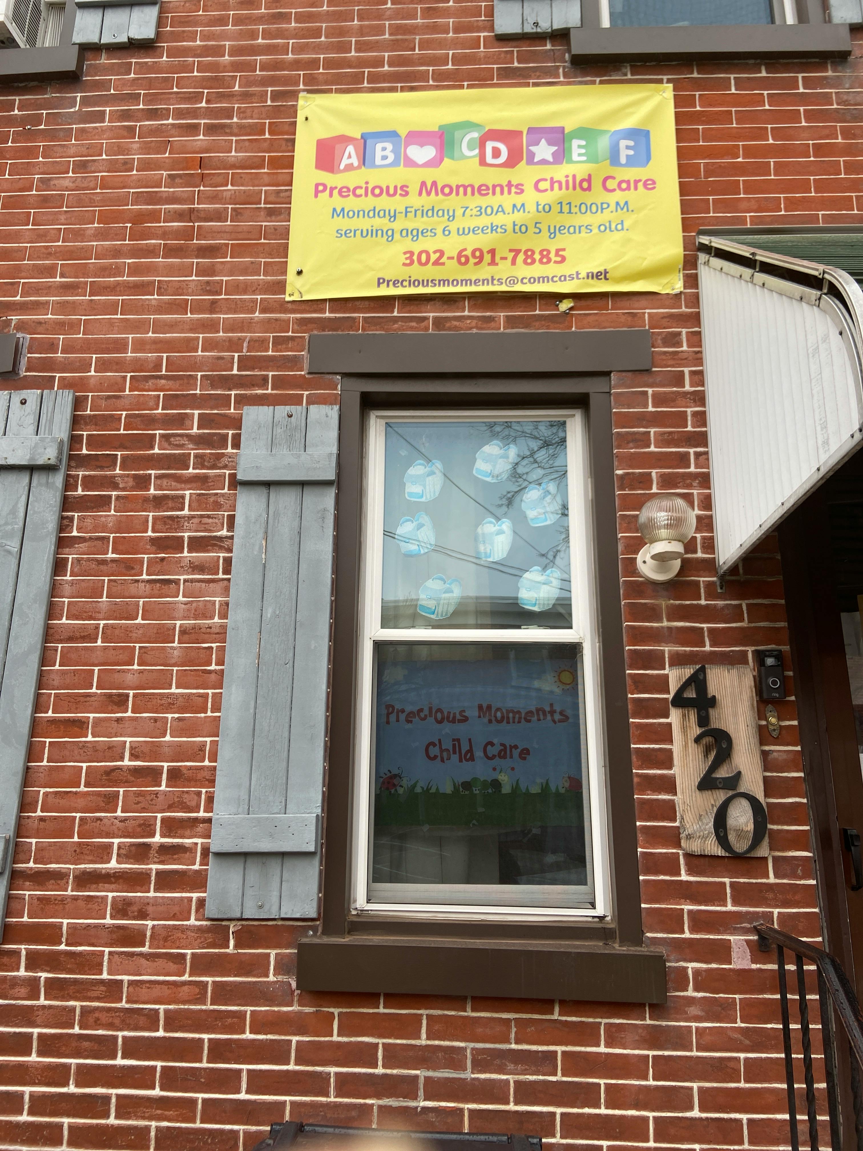 Precious Moments Child Care sign on a brick building
