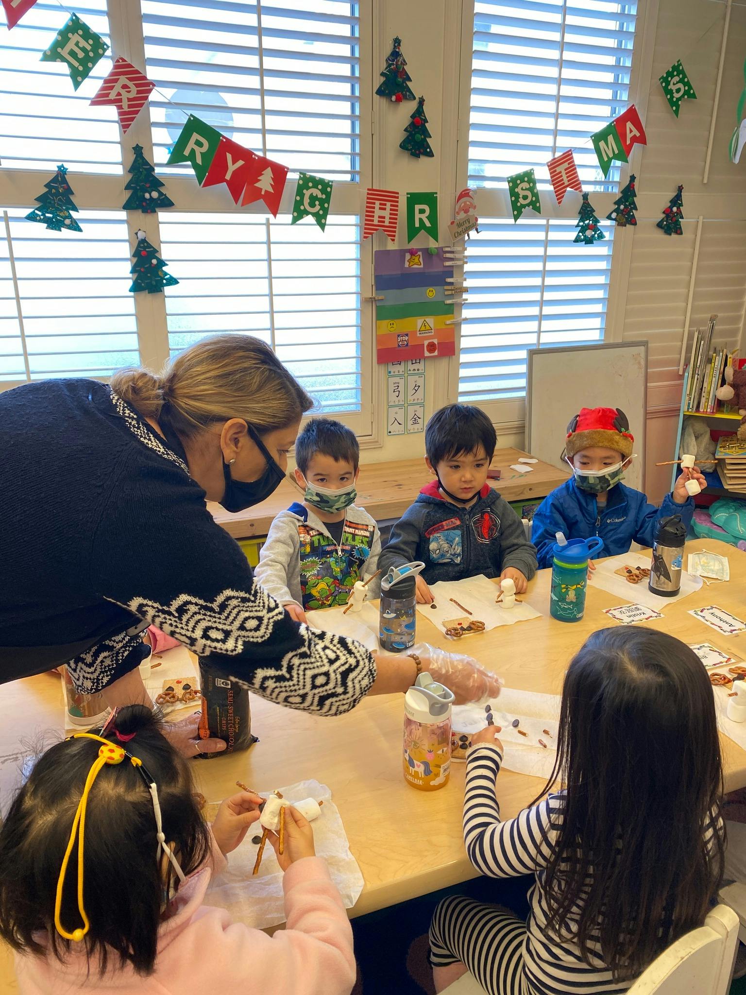 Adult and children at a table in a classroom